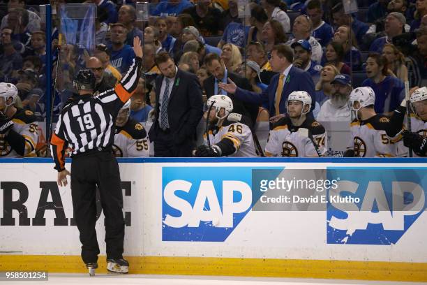 Rear view of referee Gord Dwyer making call in front of Boston Bruins bench during game vs Tampa Bay Lightning at Amalie Arena. Game 4. Tampa, FL...
