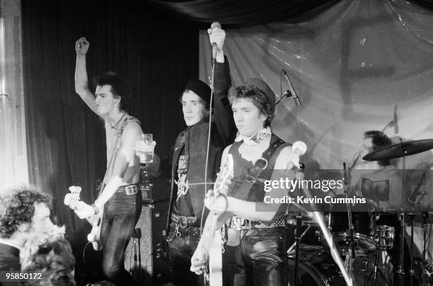 Sid Vicious, Johnny Rotten , Steve Jones and Paul Cook of British punk band the Sex Pistols perform on stage at a free concert for the children of...