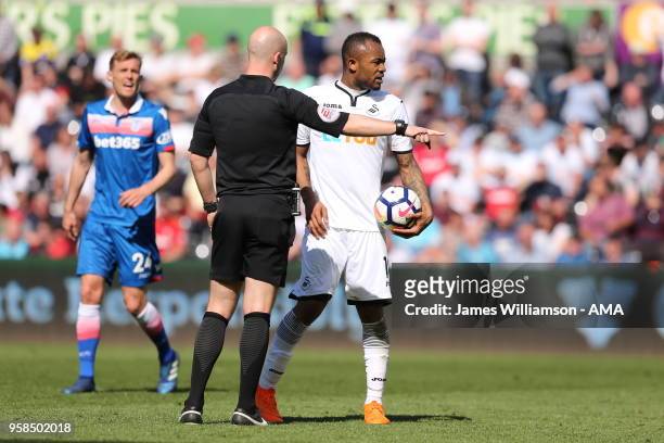 Jordan Ayew of Swansea City and match referee Anthony Taylor during the Premier League match between Swansea City and Stoke City at Liberty Stadium...
