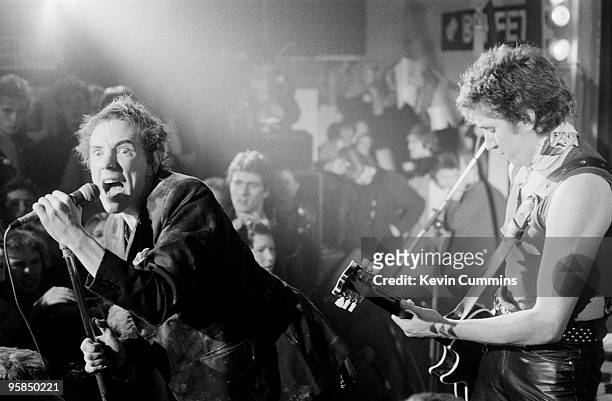 Johnny Rotten and guitarist Steve Jones of British punk band the Sex Pistols perform on stage at a free concert for the children of striking...