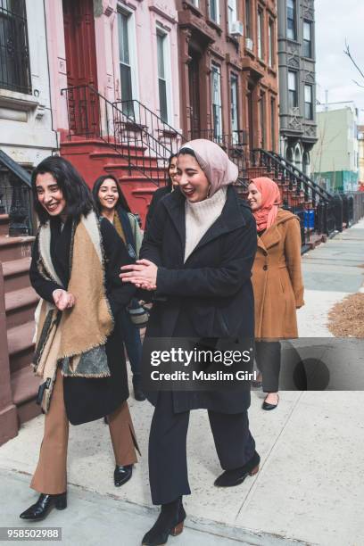 stylish muslim girls walking in a residential neighborhood - muslimgirlcollection ストックフォトと画像