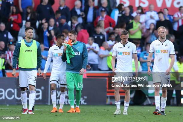 Kristoffer Nordfeldt of Swansea City and Andy King of Swansea City and Mike Van Der Hoorn of Swansea City dejected after relegation was confirmed...
