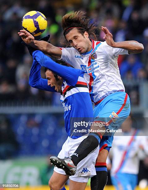 Giampaolo Pazzini of UC Sampdoria goes up for the the ball against Matias Augustin Silvestre of Catania Calcio during the Serie A match between UC...