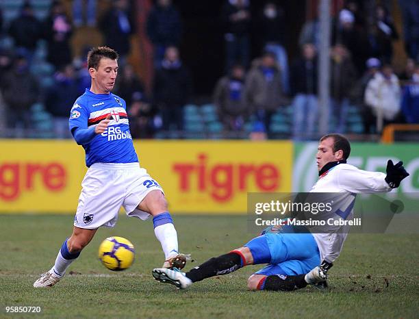 Daniele Gastaldello of UC Sampdoria battles for the the ball against Cristian Ezequiel Llama of Catania Calcio during the Serie A match between UC...