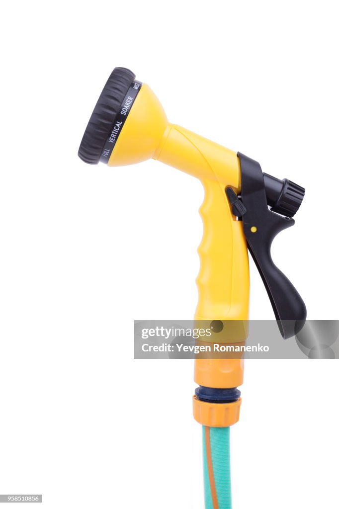 Garden nozzle Sprayer with adjustable water jet on a hose. Convenient sprayer for variable watering and cleaning tasks, isolated on white background