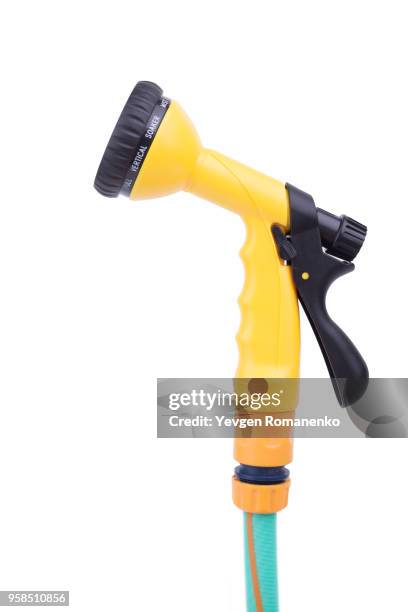 garden nozzle sprayer with adjustable water jet on a hose. convenient sprayer for variable watering and cleaning tasks, isolated on white background - squirt stockfoto's en -beelden