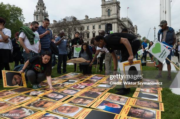 The Grenfell community of survivors, bereaved families and supporters gather in Parliament Square in central London in a peaceful protest as Members...