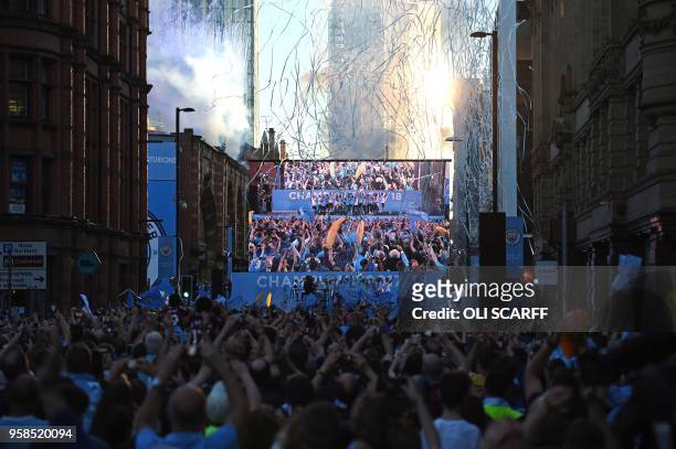 Manchester City fans line the streets to watch screens showing a televised event for fans with members of the Manchester City football team,...