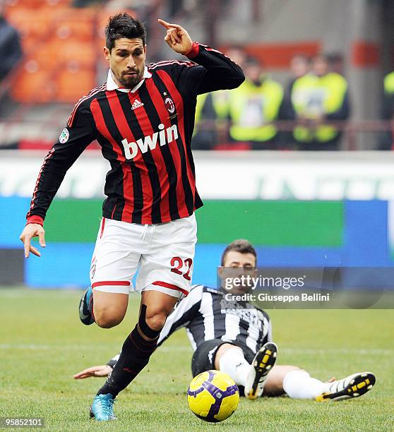 Brandao of Siena and Marco Borriello of Milan in action during the Serie A match between Milan and Siena at Stadio Giuseppe Meazza on January 17,...