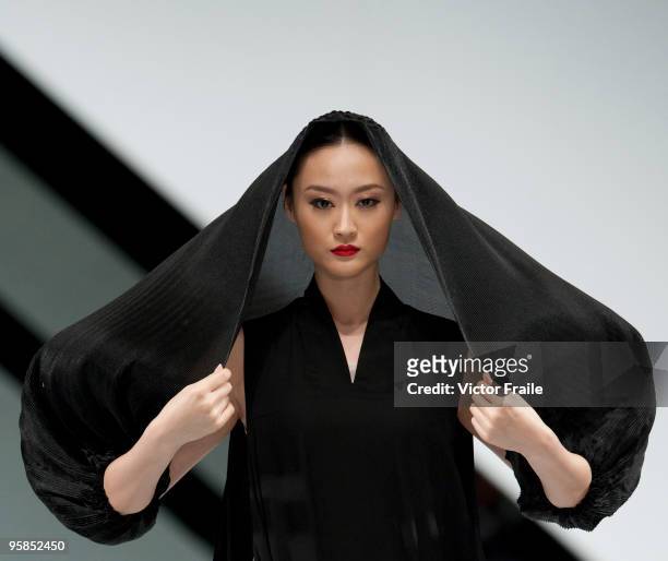 Model showcases designs by William Tang on the catwalk during the Marccain show as part of the Hong Kong Fashion Week Fall/Winter 2010 on January 18,...