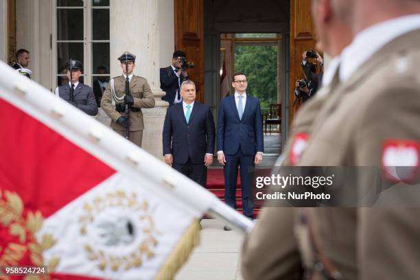 Polish Prime Minister Mateusz Morawiecki welcomes Hungarian Prime Minister Viktor Orban in front of the Lazienki Palace in Warsaw, Poland on 14 May...