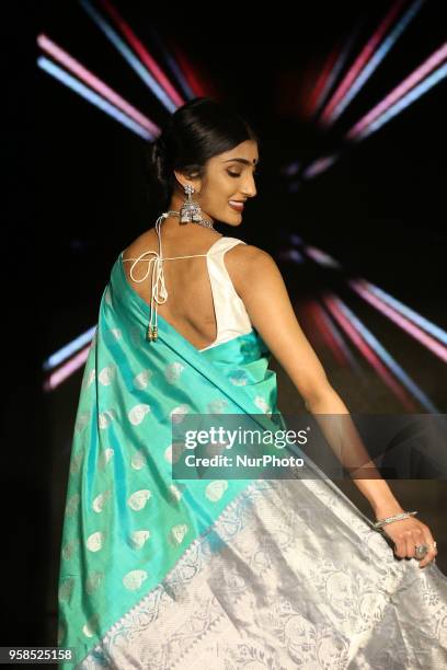 Indian woman wearing an elegant and ornate Kanchipuram saree during a South Indian fashion show held in Scarborough, Ontario, Canada.