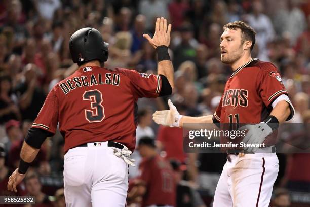 Pollock of the Arizona Diamondbacks is congratulated by Daniel Descalso after scoring in the sixth inning of the MLB game against the Houston Astros...