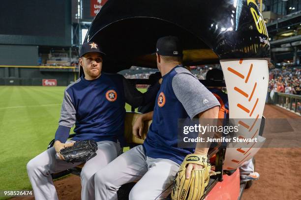 Collin McHugh and Brad Peacock of the Houston Astros take a ride in the bullpen cart prior to the MLB game against the Arizona Diamondbacks at Chase...