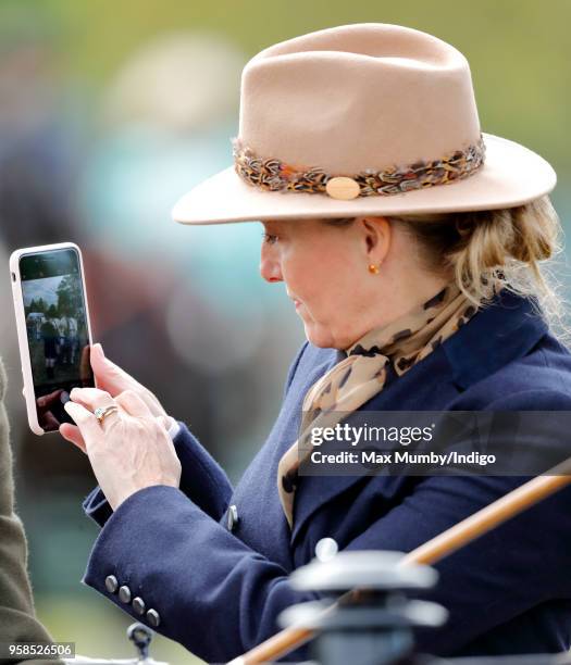 Sophie, Countess of Wessex takes photographs using her iPhone as she takes part in The Champagne Laurent-Perrier Meet of the British Driving Society...