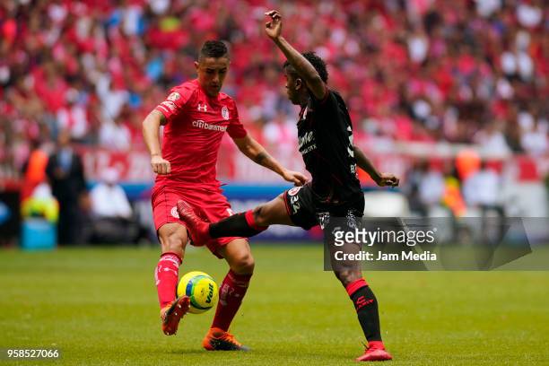 Osvaldo Gonzalez of Toluca and Miller Bolanos of Tijuana compete for the ball during the semifinals second leg match between Toluca and Tijuana as...