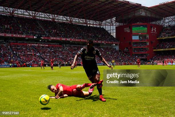 Rodrigo Salinas of Toluca and Miller Bolaños of Tijuana compete for the ball during the semifinals second leg match between Toluca and Tijuana as...