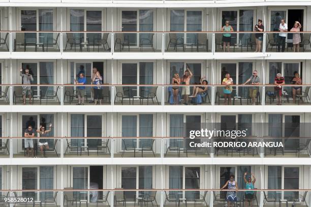 Passengers of a cruise ship wave while crossing the Panama Canal in the Agua Clara locks in Colon 80 km northwest from Panama City. The Norwegian...