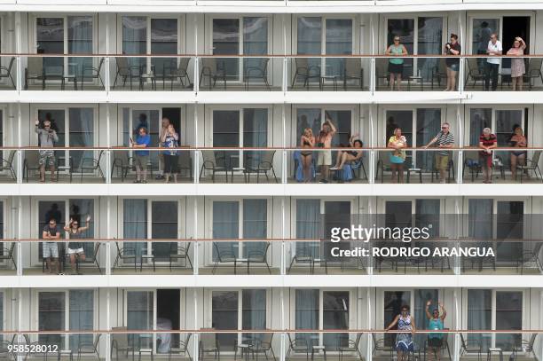 Passengers of a cruise ship wave while crossing the Panama Canal in the Agua Clara locks in Colon 80 km northwest from Panama City. The Norwegian...