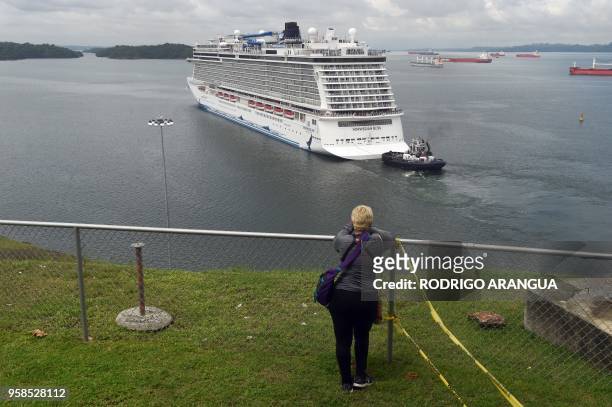 Visitor looks at a cruise ship crossing the Panama Canal in the Agua Clara locks in Colon 80 km northwest from Panama City. The Norwegian Cruise...
