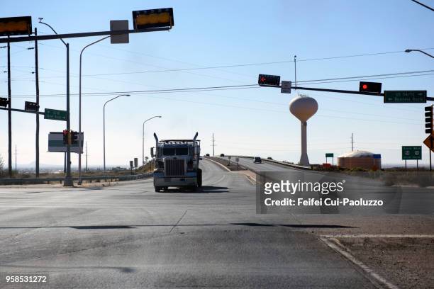 water tower and highway at alamogordo, new mexico, usa - alamogordo stock pictures, royalty-free photos & images