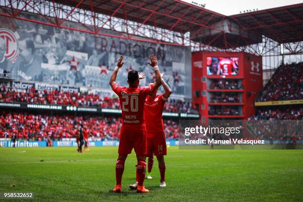 Fernando Uribe of Toluca celebrates with Rubens Sambueza after scoring his second goal during the semifinals second leg match between Toluca and...