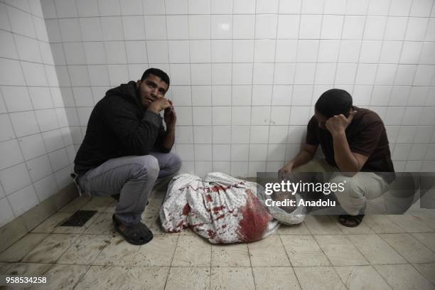 Relatives of Fadi Abu Salah, who lost his legs during an Israeli assault on 2008, mourn at a hospital's morgue after Israel's intervention during a...