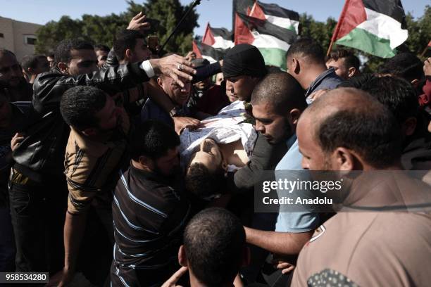 Mourners carry dead body of Fadi Abu Salah, who lost his legs during an Israeli assault on 2008, and has been killed in Israeli security forces'...