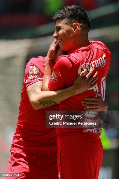 Pablo Barrientos of Toluca celebrates with teammate Rodrigo Salinas after scoring the fourth goal of his team during the semifinals second leg match...