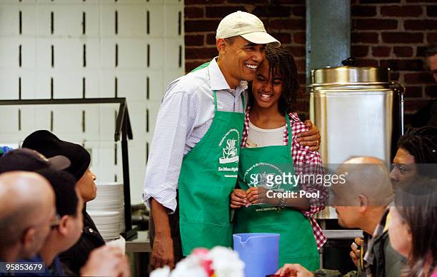 President Barack Obama and his daughter Malia honor the Martin Luther King legacy by serving meals to the needy at a facility January 18, 2010 in...