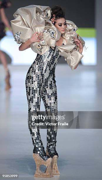 Model showcases designs by Guo Pei of China on the catwalk during the HK Fashion Extravaganza 2010 show as part of the Hong Kong Fashion Week...