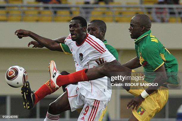 Aigles du Mali, the national football team of Mali, player Mamadou Bagayoko vies for the ball Malawi's Russell Mwafulirwa on January 18, 2010 at the...