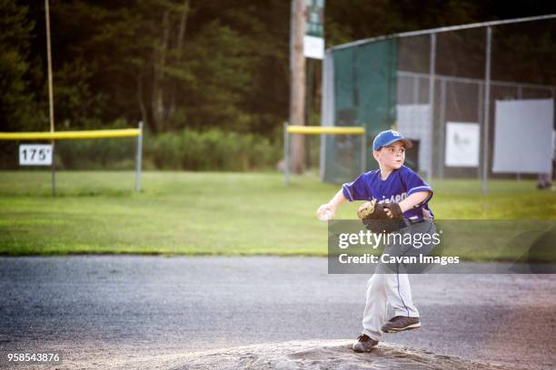 confident player throwing ball - kid baseball pitcher stock pictures, royalty-free photos & images