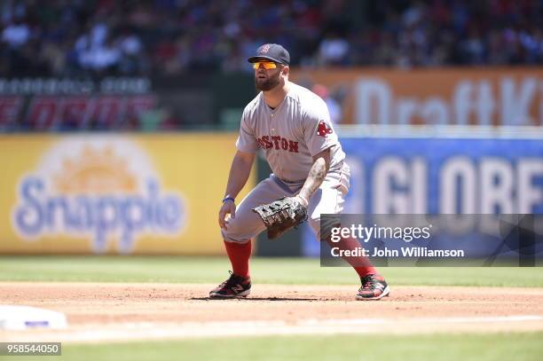 First baseman Mike Napoli of the Boston Red Sox looks to home plate as the pitch is delivered in the game against the Texas Rangers at Globe Life...