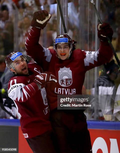 Kristian RUuins of Latvia celebrate with team mate Roberts Bukarts after he scores a goal the 2018 IIHF Ice Hockey World Championship Group B game...