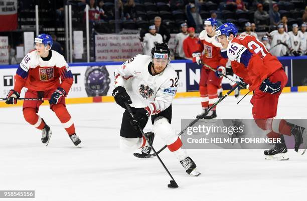 Austria's Michael Raffl and Czech Republic's Jakub Krejcik vie during the group A match Czech Republic vs Austria of the 2018 IIHF Ice Hockey World...