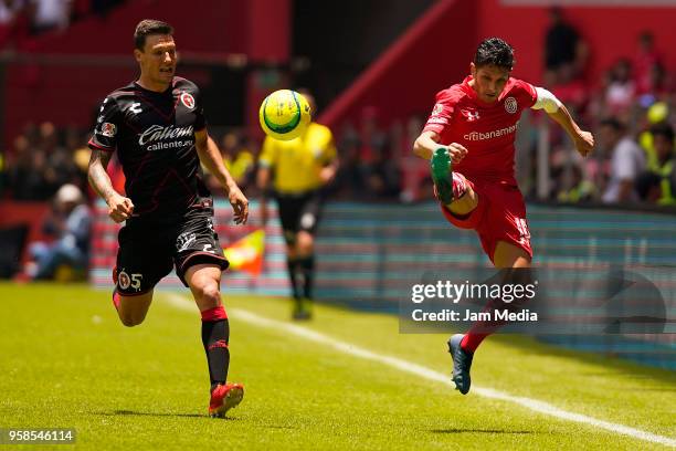 Angel Reyna of Toluca kicks the ball against Damian Musto of Tijuana during the semifinals second leg match between Toluca and Tijuana as part of the...