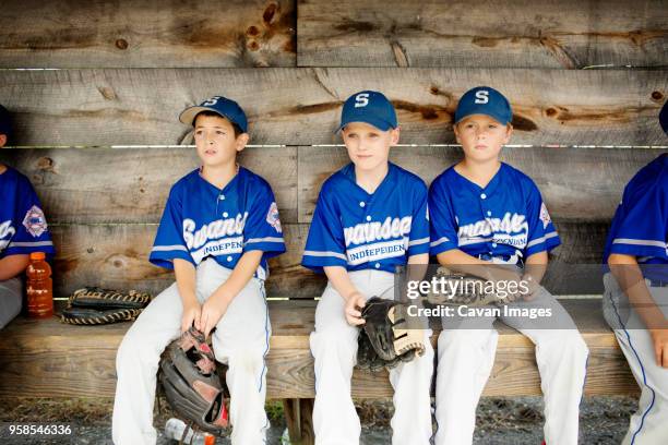 players looking away while relaxing on bench - bench dedication stock pictures, royalty-free photos & images