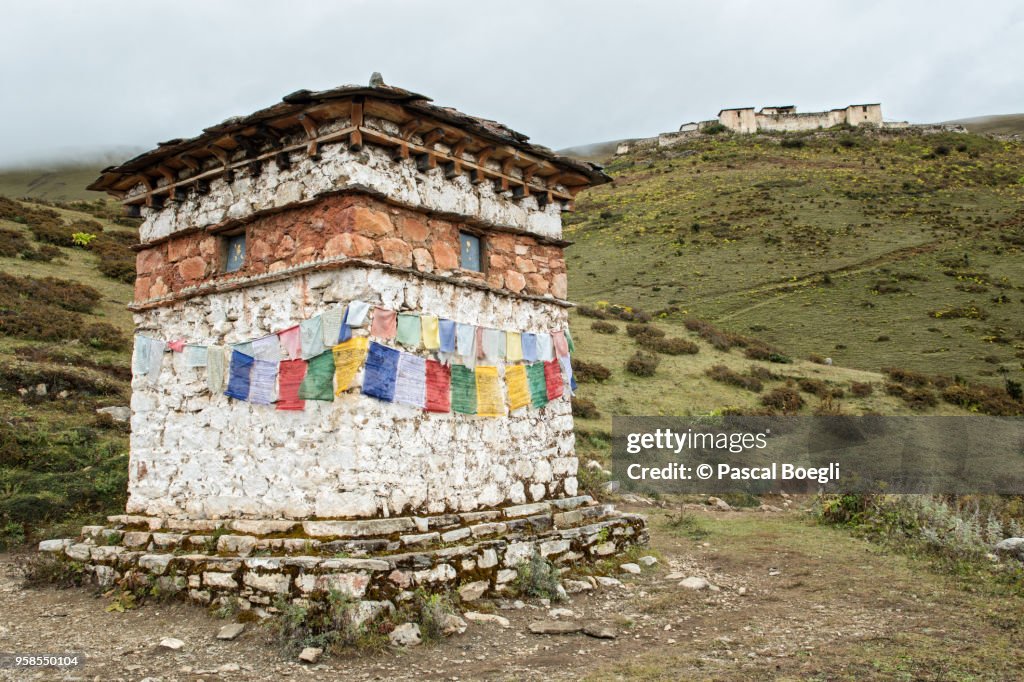 Chorten with prayer flags near the Lingshi dzong, Thimphu District, Snowman Trek, Bhutan