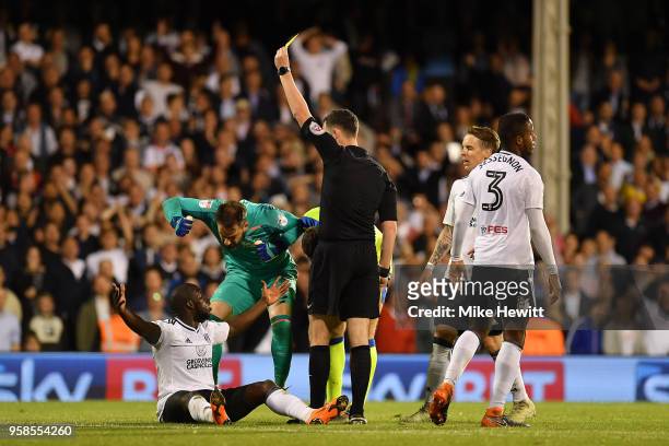Aboubakar Kamara of Fulham is shown a yellow card by referee Chris Kavanagh during the Sky Bet Championship Play Off Semi Final, second leg match...