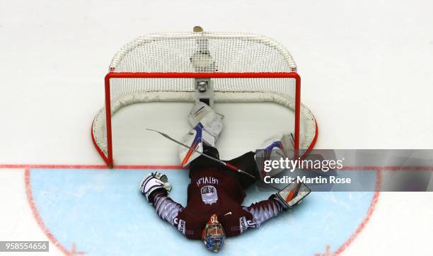 Kristers Gudlevskis, goaltender of Latvia lies dejected on the ice after losing against Canada during extra time during the 2018 IIHF Ice Hockey...