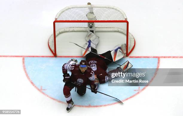 Kristers Gudlevskis, goaltender of Latvia and team mate Kristaps Sotnieks look dejected after losing against Canada during extra time during the 2018...