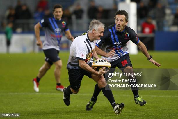 France's coach Didier Deschamps plays rugby during the charity match organized by French football player Pascal Olmeta for his association "Un...