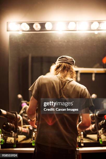 rear view of rock musician preparing for music concert - backstage stock pictures, royalty-free photos & images