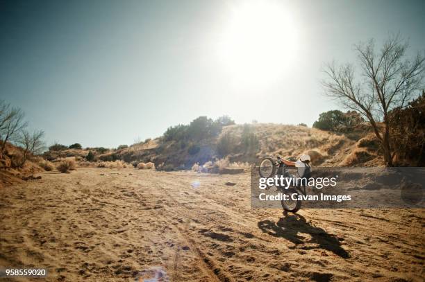 man on motorcycle performing wheelie - stuntman stockfoto's en -beelden