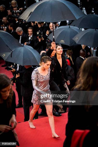 Kristen Stewart walks with bare feet at the screening of 'BlacKkKlansman' during the 71st annual Cannes Film Festival at Palais des Festivals on May...