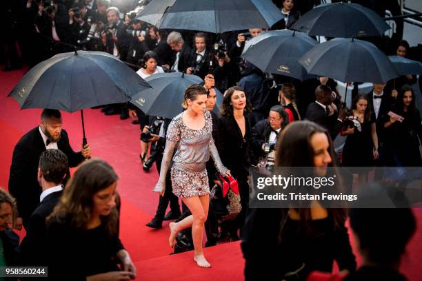 Kristen Stewart walks with bare feet at the screening of 'BlacKkKlansman' during the 71st annual Cannes Film Festival at Palais des Festivals on May...