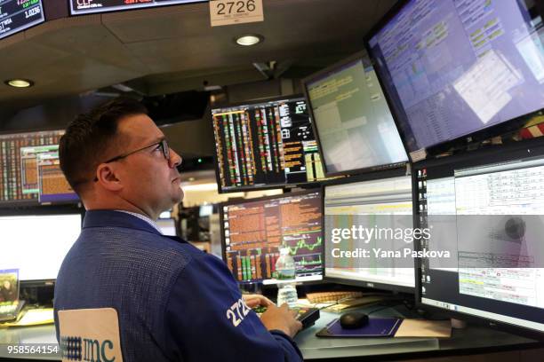 Traders work on the floor at the New York Stock Exchange after the ringing of the closing bell on May 14, 2018 in New York City. U.S. Stocks rose...