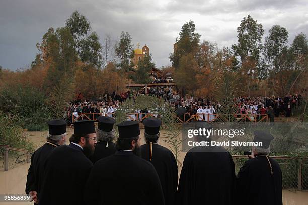 Greek-Orthodox priests stand on the western bank of the river as pilgrims gather across the water in neighbouring Jordan for the Epiphany...