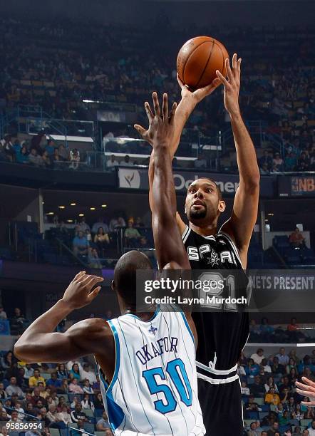 Tim Duncan of the San Antonio Spurs shoots over Emeka Okafor of the New Orleans Hornets on January 18, 2010 at the New Orleans Arena in New Orleans,...